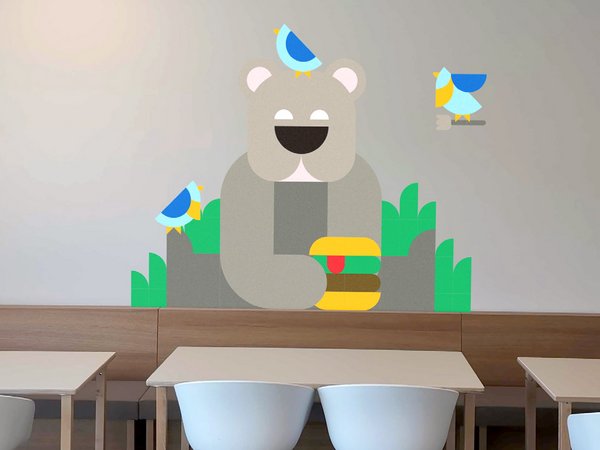 Dining area where there is an illustration of a bear with a burger on the wall