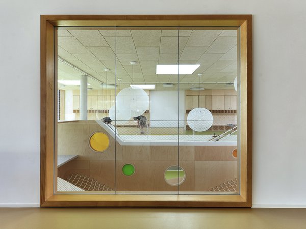 Mirror showing the staircase in with the dots of the logo on the wall