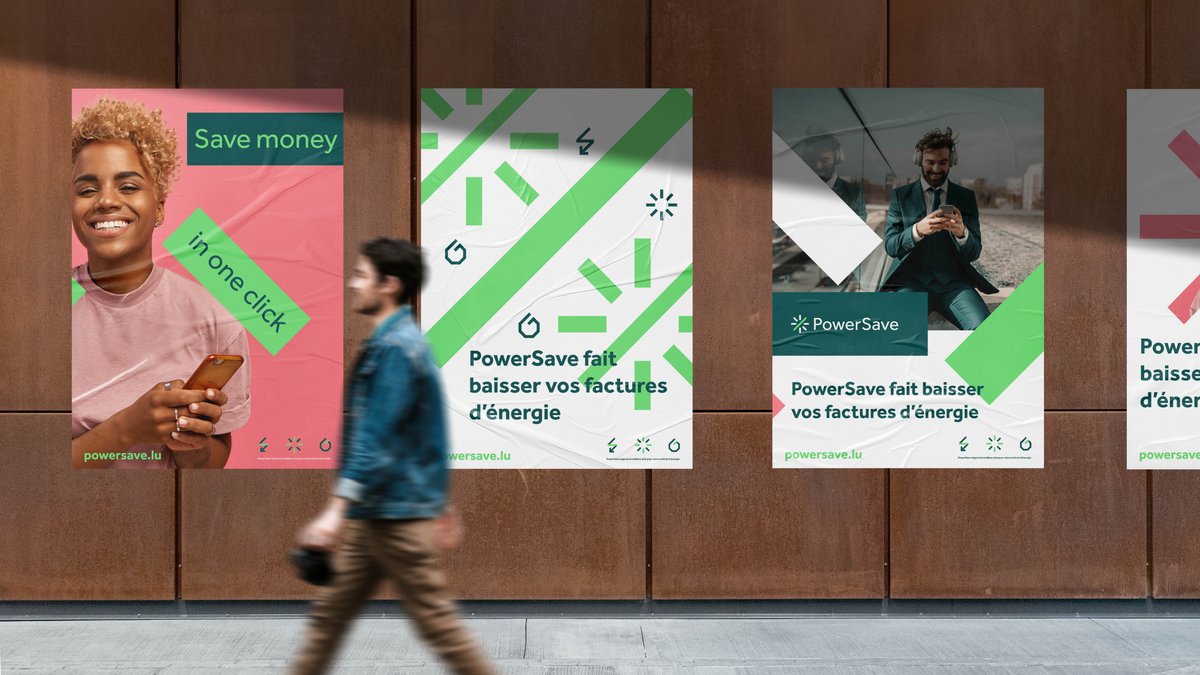 Posters on a street wall featuring powersave's new branding